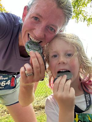 Everett and I crushing our medals at last year's Zoo run!